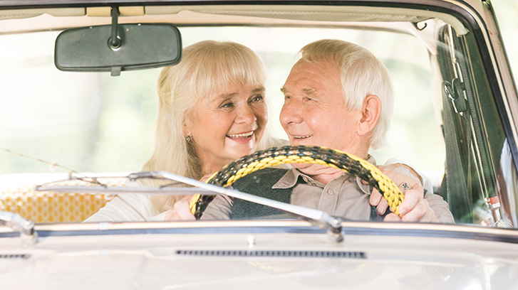 happy senior driving car